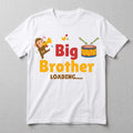 May include: White t-shirt with a colorful graphic design. The design features a cartoon monkey playing a trumpet, a drum, and the text "Big Brother LOADING....." in red and yellow. Hearts are also included.