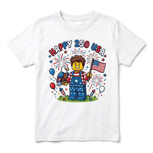 May include: White t-shirt with a colorful graphic celebrating the 250th anniversary of the USA. The design features a Lego-style figure holding an American flag and an eagle, surrounded by fireworks, balloons, and the text "HAPPY 250 USA."